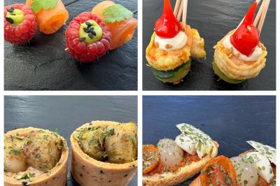 Assortiment de bouchées apéritives variées présentées sur une ardoise noire.